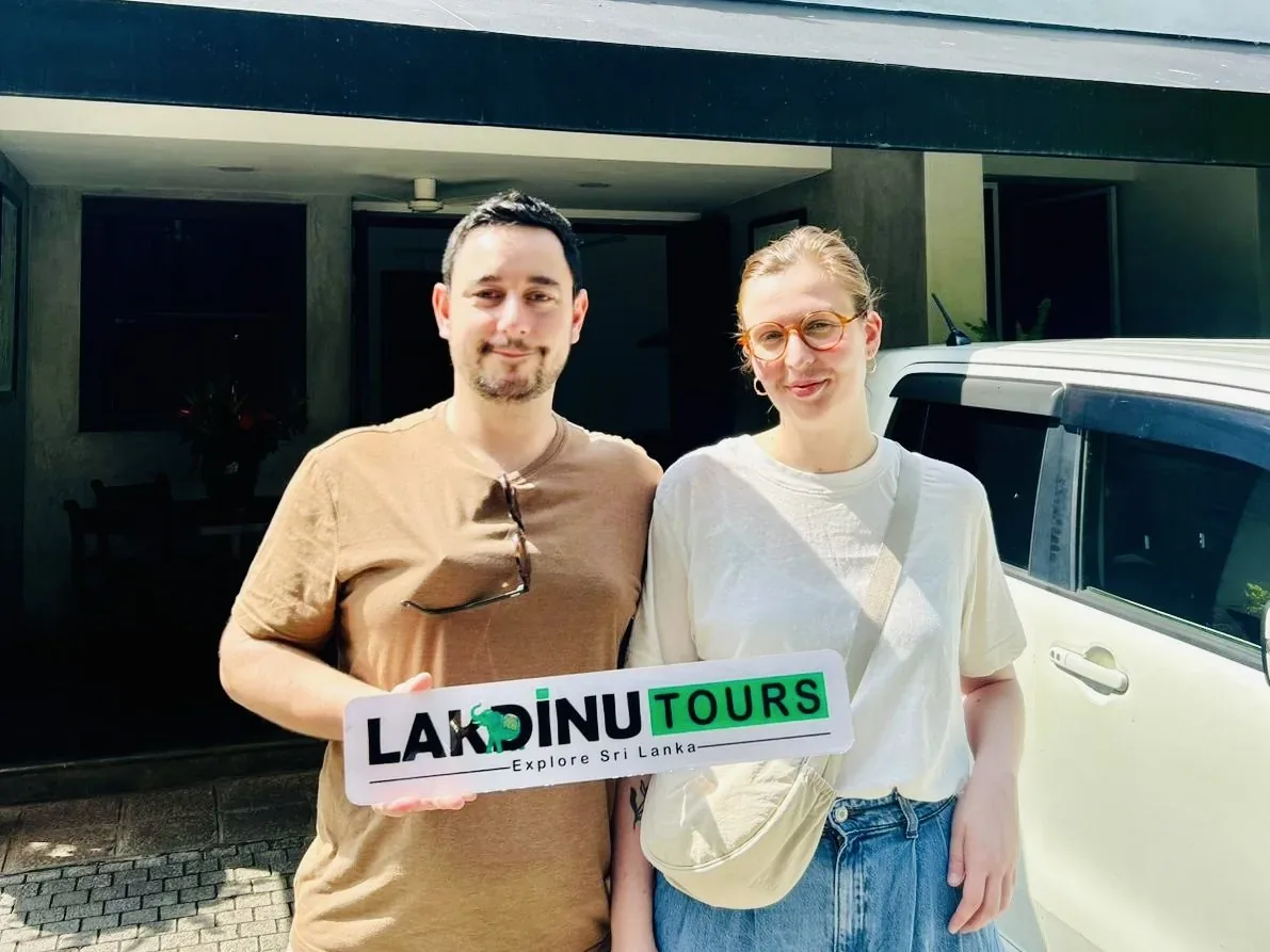 Happy tourist couple arriving at a hotel with their private driver in Sri Lanka.
